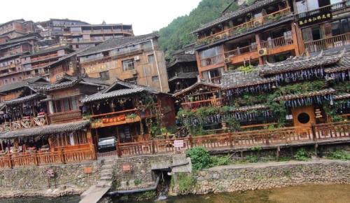 Be sure to visit tourist attraction in Guizhou, largest Miao village in world, although it is now very commercialized.