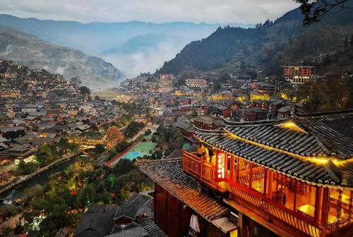 Be sure to visit tourist attraction in Guizhou, largest Miao village in world, although it is now very commercialized.