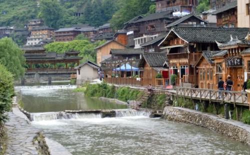 Be sure to visit tourist attraction in Guizhou, largest Miao village in world, although it is now very commercialized.