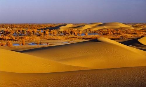 How deep is Takla Makan Desert? If you dig up all the sand, what's under it?