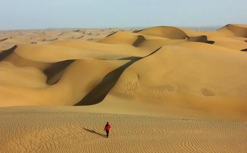 How deep is Takla Makan Desert? If you dig up all the sand, what's under it?